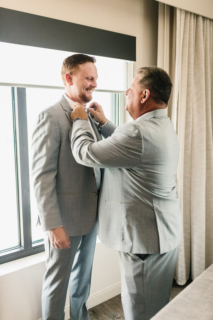groom getting ready with his dad