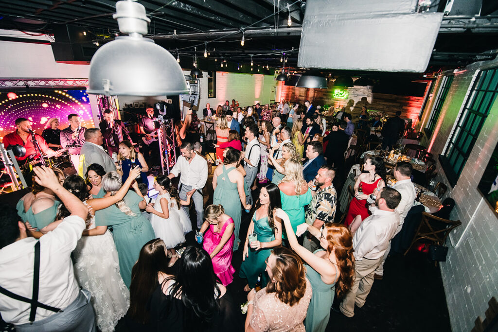 all of the wedding guests dancing at the reception in The West Events