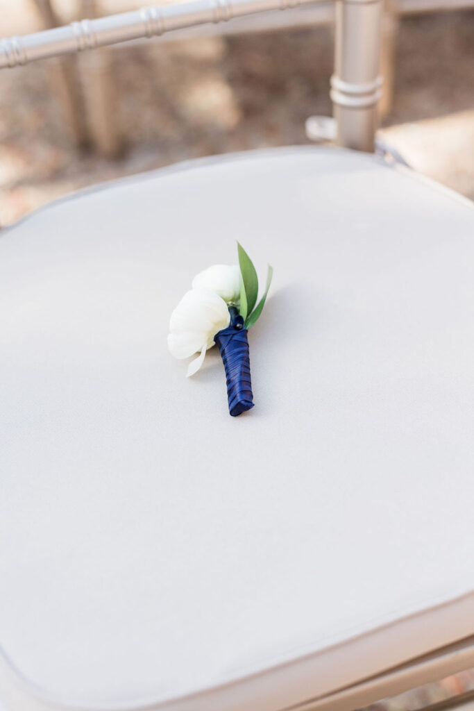 memory chair at wedding ceremony lush white wedding florals on Socialite Event Planning Florida