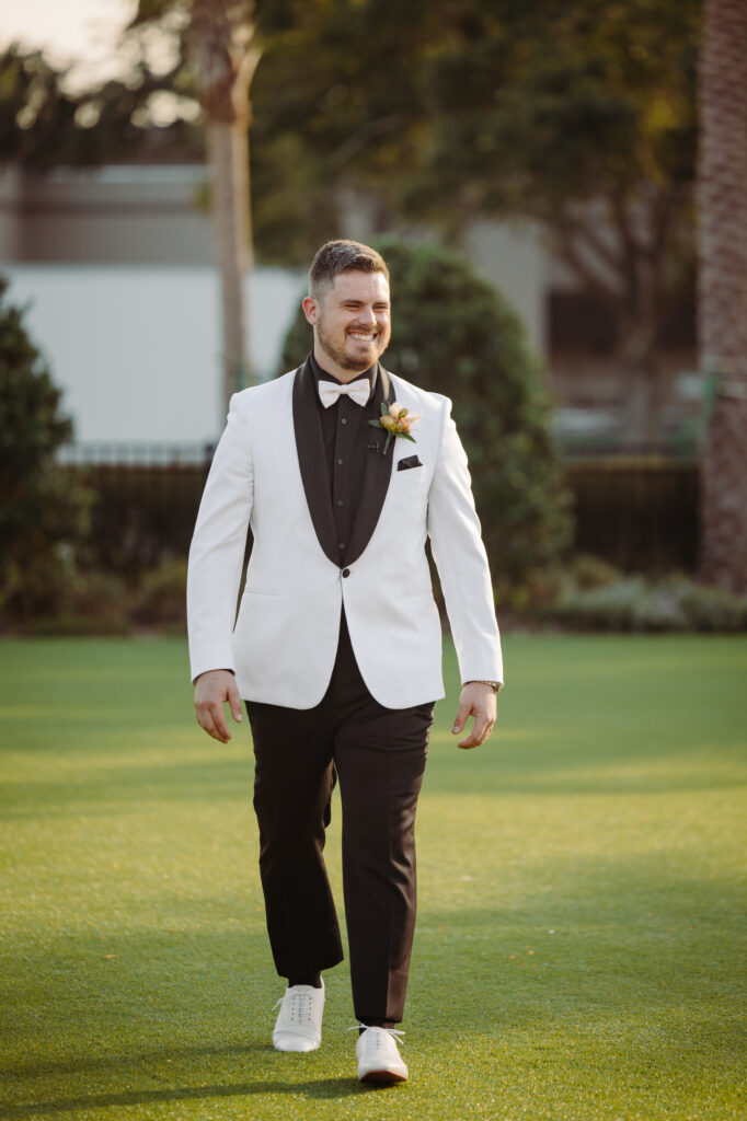 groom in white tux jacket at destination wedding near Airport Orlando