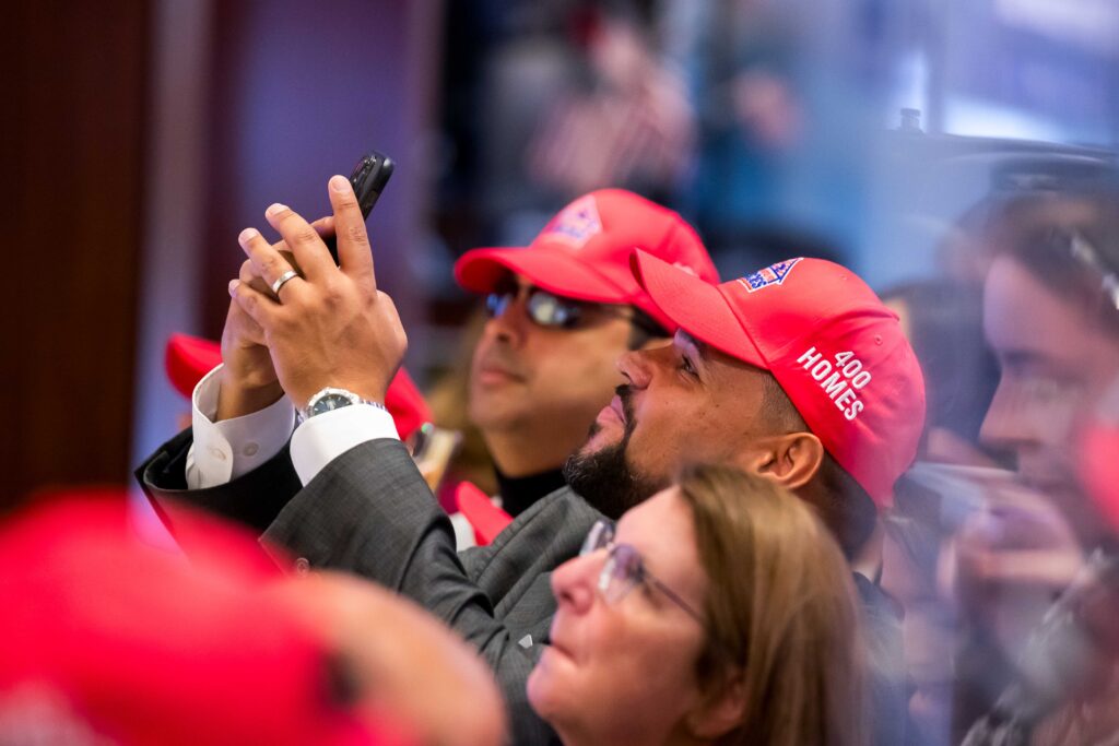 people wearing red hats at NYSE for charity gala