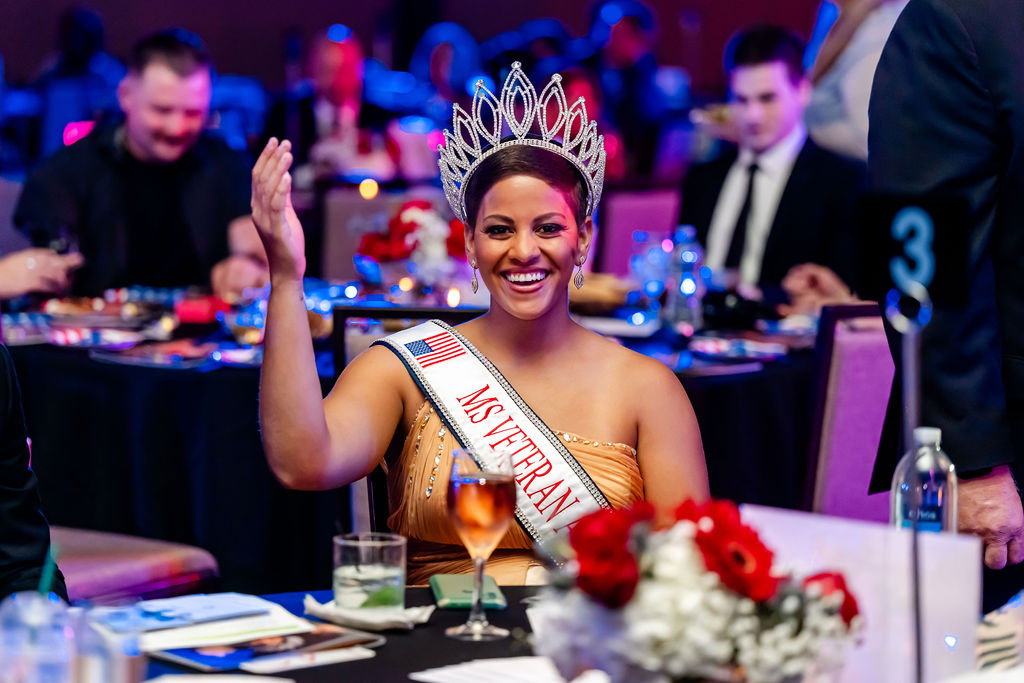 Ms Veteran America waving at camera