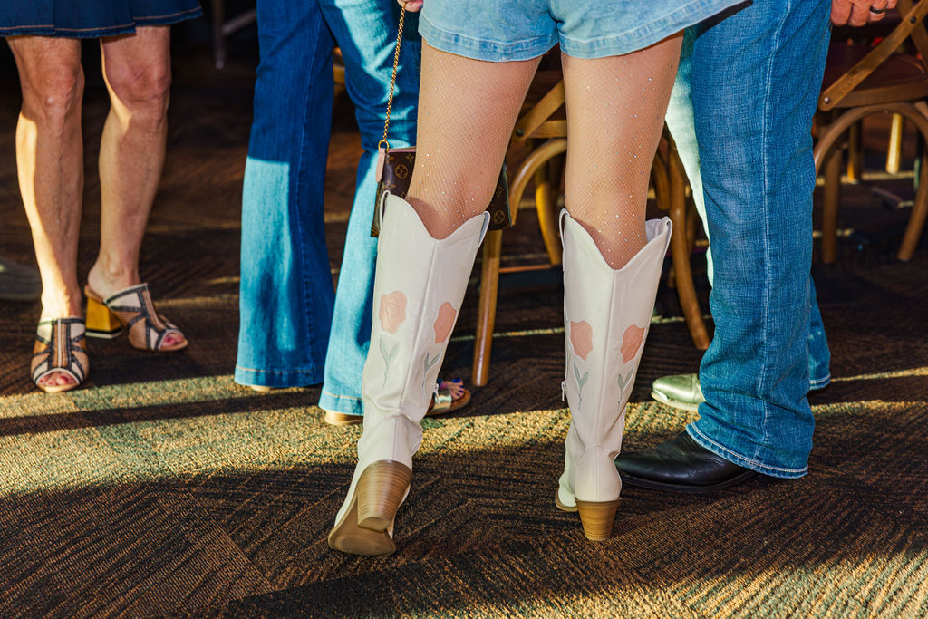 Woman wearing sparkly leggings with white and floral boots