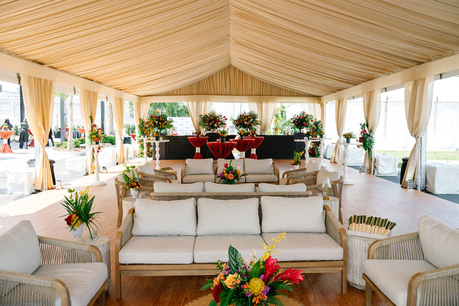 draped tent lounge area with elevated event decor at corporate branded event