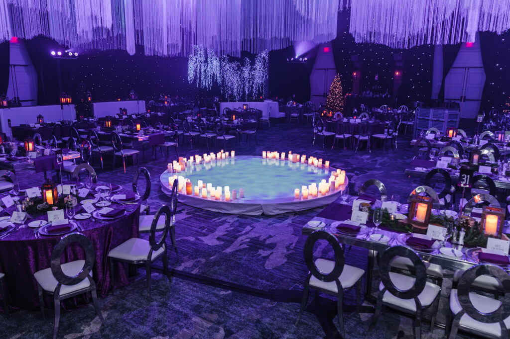 Circular dance floor with the illusion of water surrounded by faux candles